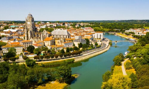 Picturesque summer view of historic areas of Saintes located on Charente river looking out over cathedral bell tower in Flamboyant Gothic style, Charente-Maritime, France